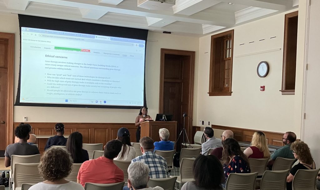 Jackline Masetu presenting her DSSRF project in front of a room full of people.